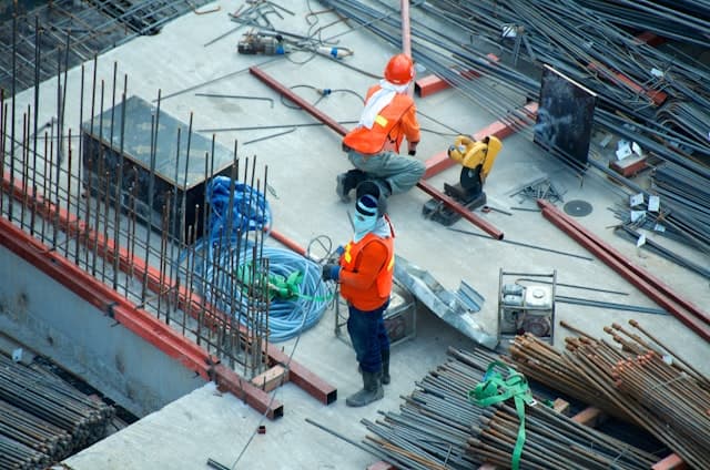 Contractor reviewing blueprints on job site